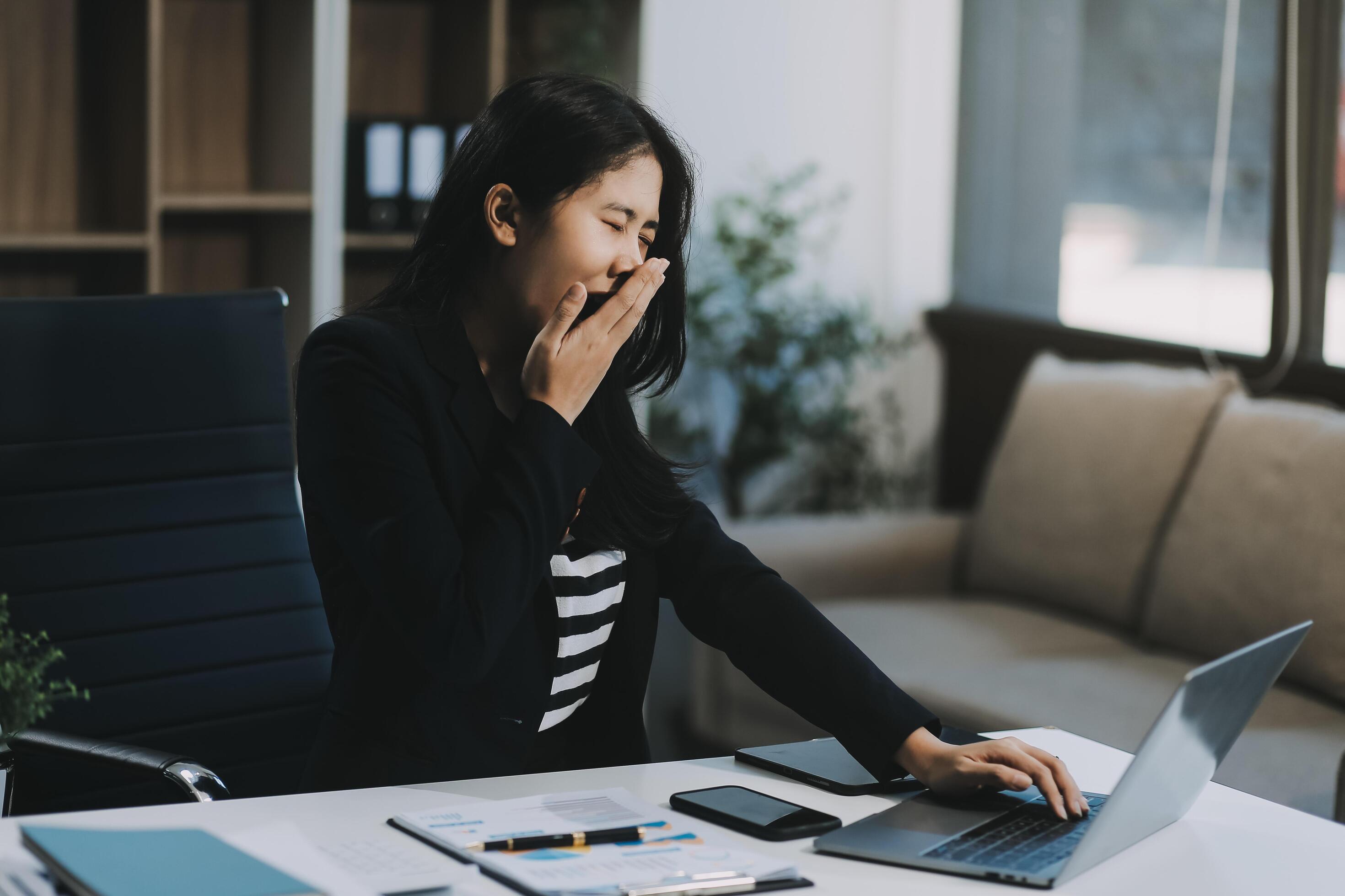 Office asian business woman stretching body for relaxing while working with laptop computer at her desk, office lifestyle, business situation Stock Free