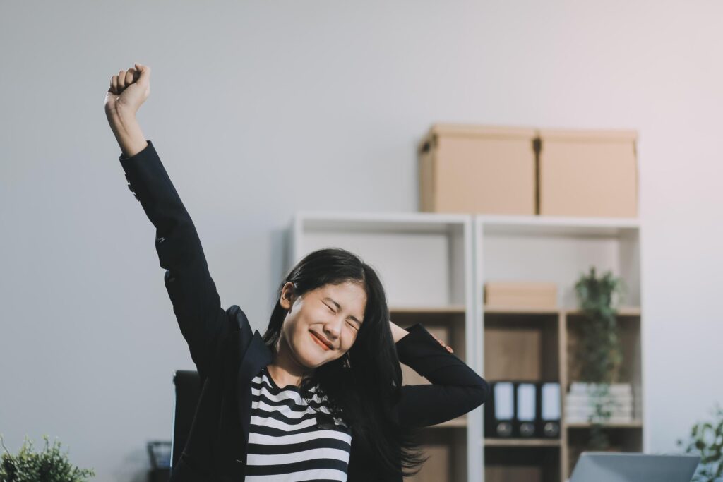 Office asian business woman stretching body for relaxing while working with laptop computer at her desk, office lifestyle, business situation Stock Free