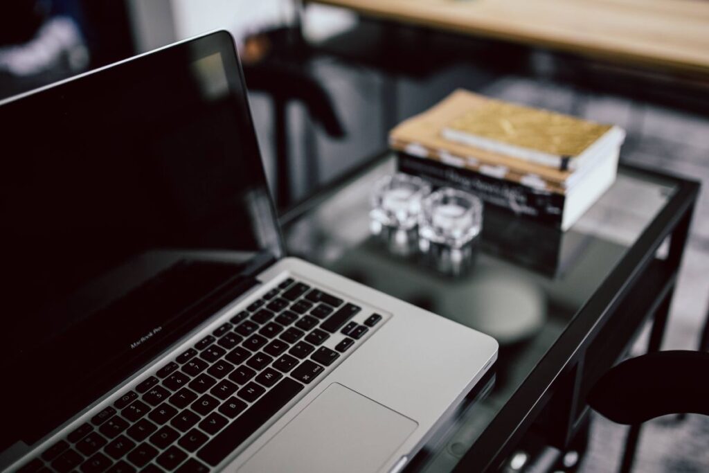 Organized desk with laptop and journals Stock Free