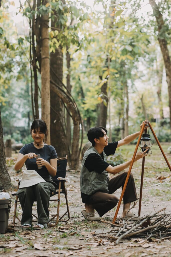 Asian couple sweet in tent inside on they camping trip, traveller relax and sleep togather in out door and camping trip Stock Free