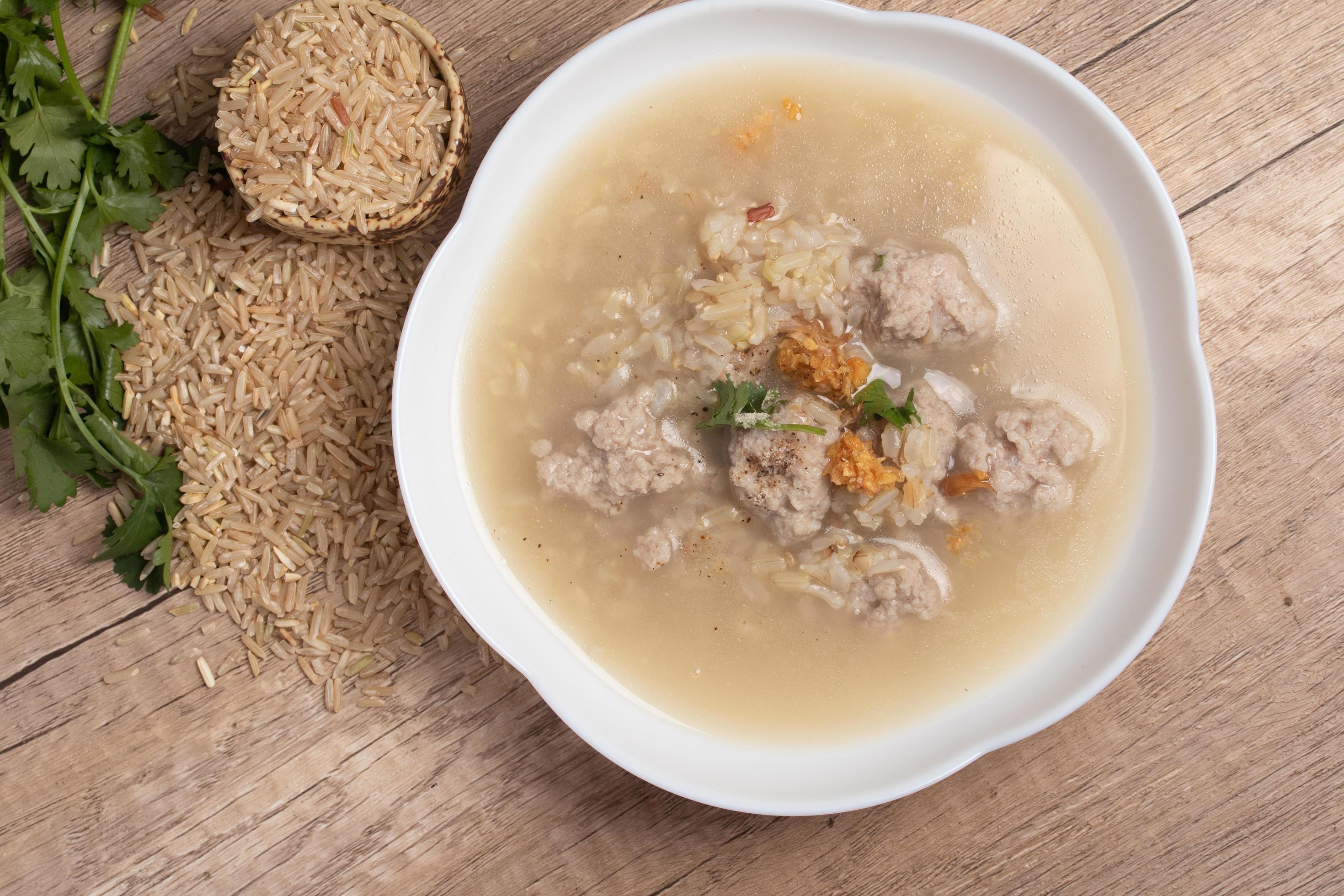 Jasmine brown rice porridge with pork on wooden background.Healthy food copy space Stock Free