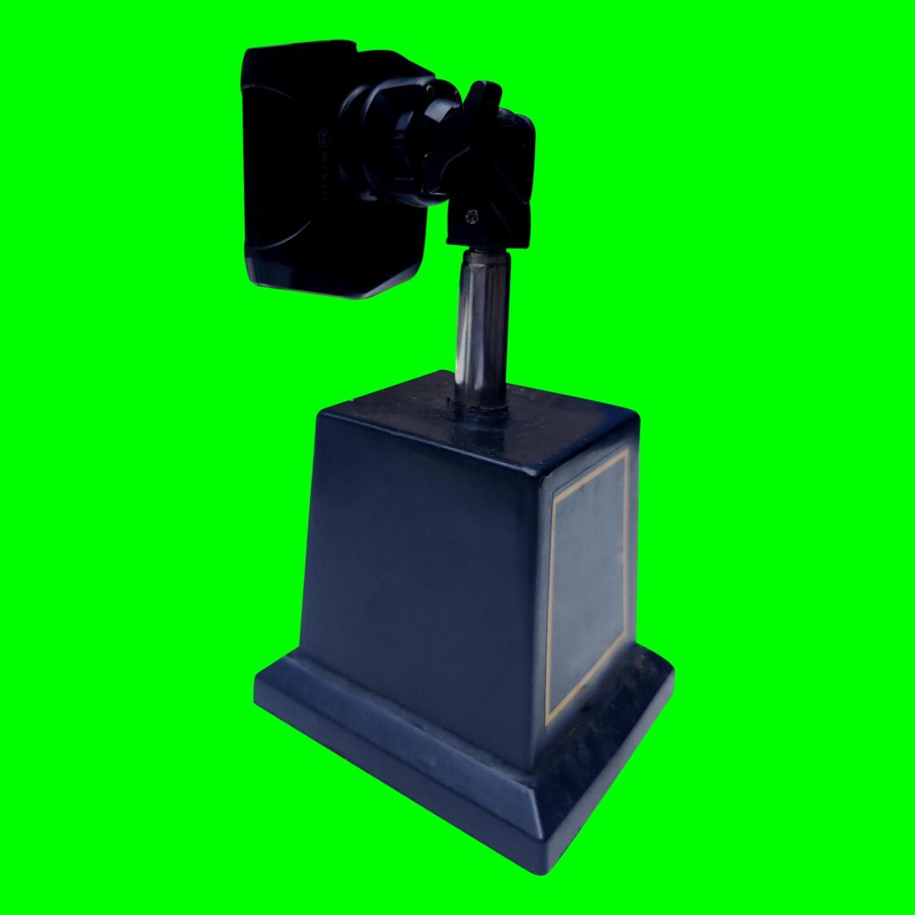 Smartphone holder, tool for photography, made of plastic and stainless with a green background texture Stock Free