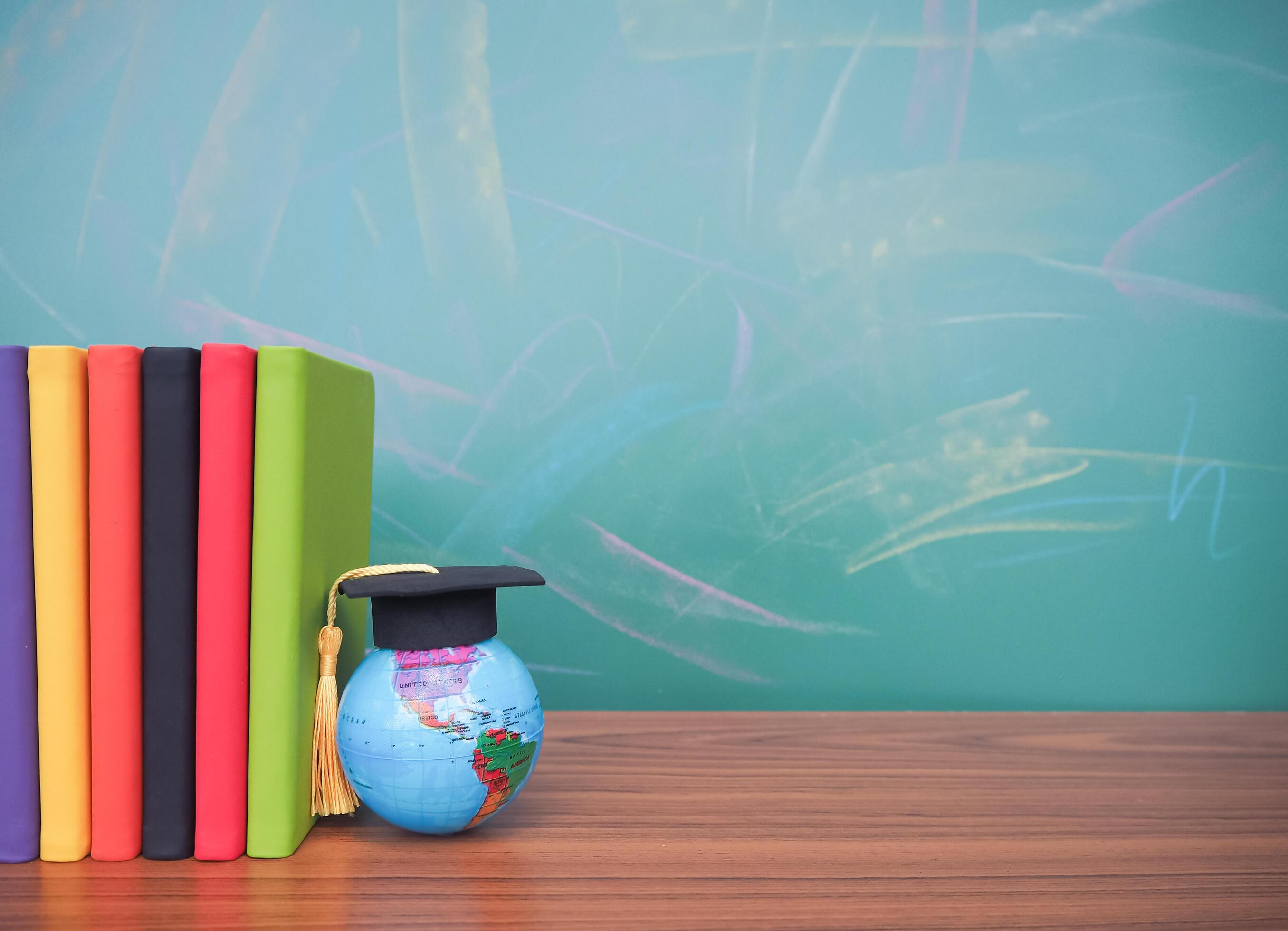 Student creative desktop , earth globe with graduation hat and hardcover book. Copy space for text, Back to school, Education concept Stock Free