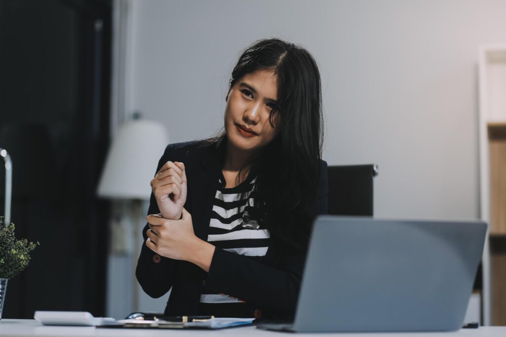 Office asian business woman stretching body for relaxing while working with laptop computer at her desk, office lifestyle, business situation Stock Free