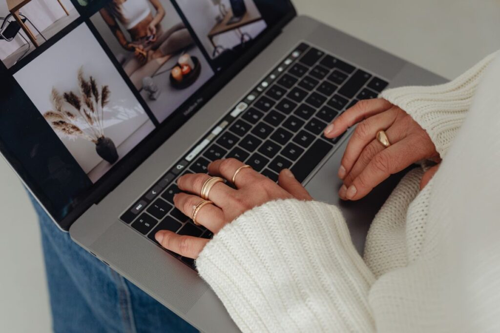 Woman in a white sweater – jewelry – laptop work – fashion Stock Free