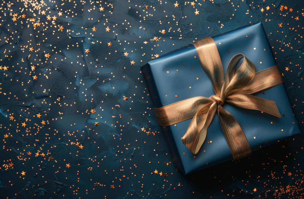 Gift Box With Gold Ribbon on Blue Background Stock Free