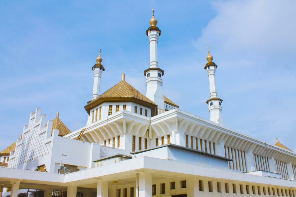 Grand white mosque with golden domes, blue sky background, Tasikmalaya, West Java, Indonesia Stock Free