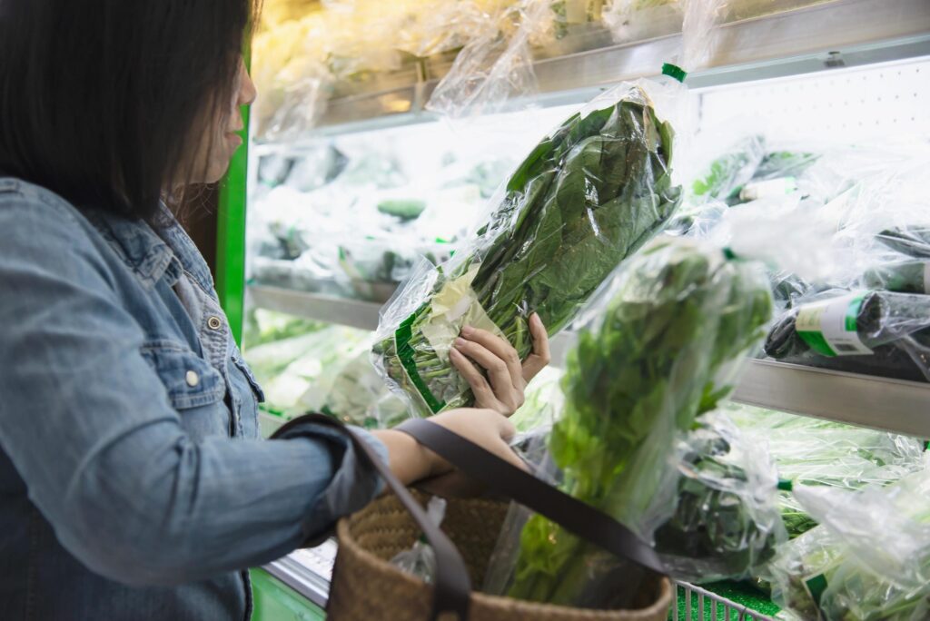 Lady is shopping fresh vegetable in supermarket store – woman in fresh market lifestyle concept Stock Free