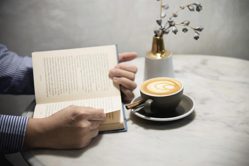 Man read book with beautiful fresh relax morning coffee cup – people relax and coffee lifestyle background concept Stock Free