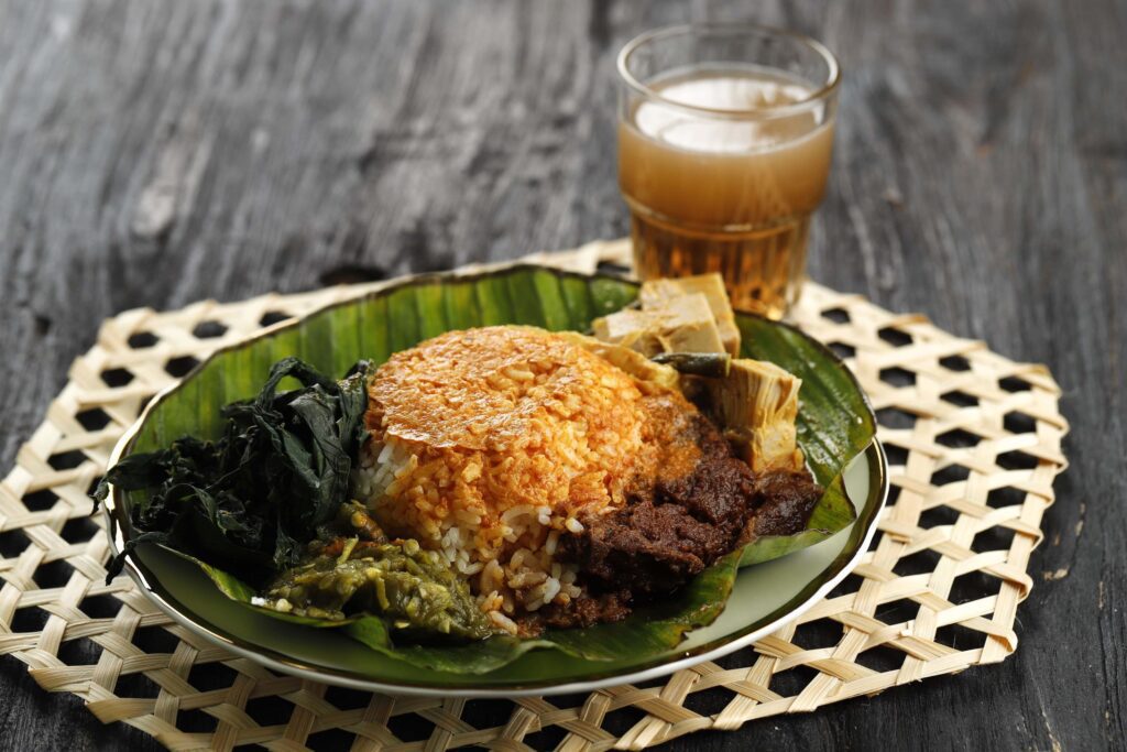 Nasi Padang or Padang Rice is a famous traditional food from Indonesia. Rice with beef Rendang, cassava leaves and Green Chili Paste. Stock Free