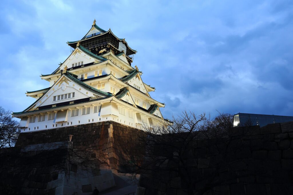 Osaka Castle in Osaka, Japan illuminated by spotlights during dusk. Stock Free