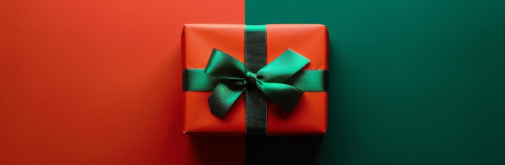 Red Gift Box With Green Bow on Green and Red Background Stock Free