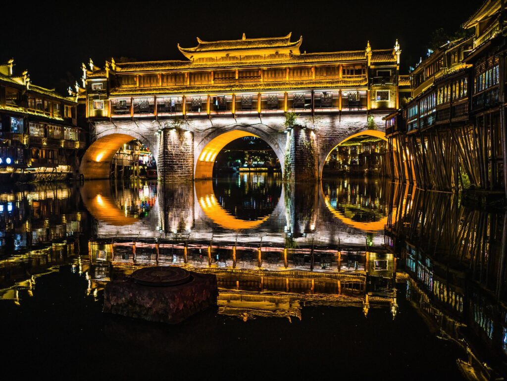 Scenery view of hong bridge and building in the night of fenghuang old town .phoenix ancient town or Fenghuang County is a county of Hunan Province, China Stock Free