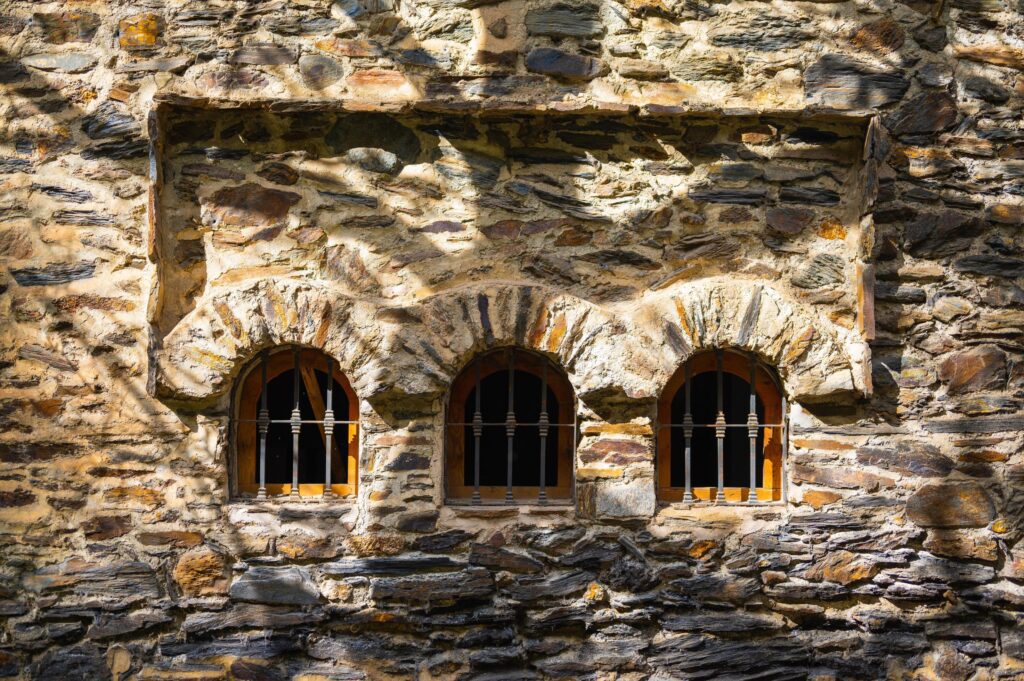 Stone window arches with tree shadows Stock Free