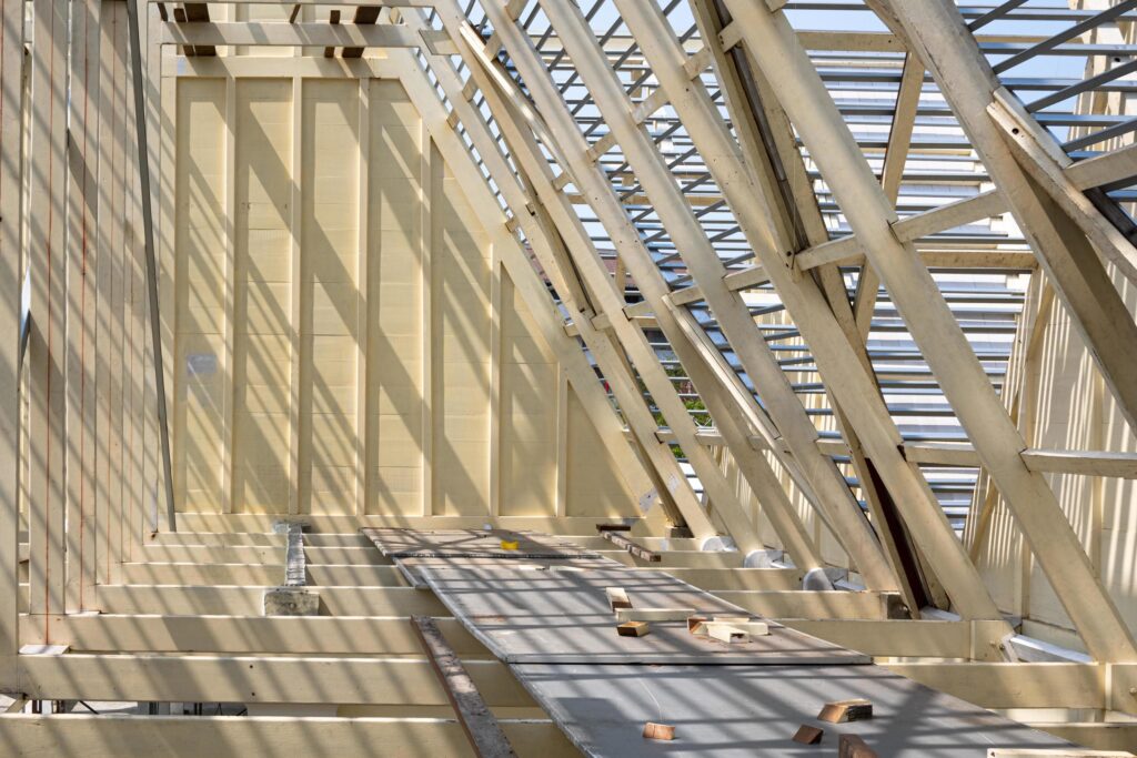 Sunlight and shadow on surface of white wooden roof truss structure with material under construction, renovation and architecture concept Stock Free