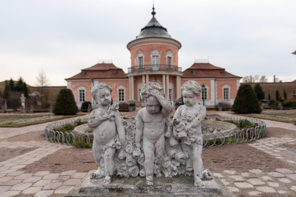 Three statues of boys in front polish castle, on the territory of modern Ukraine. Stock Free