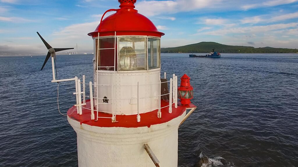 White lighthouse with red roof on Tokarev cat. Stock Free