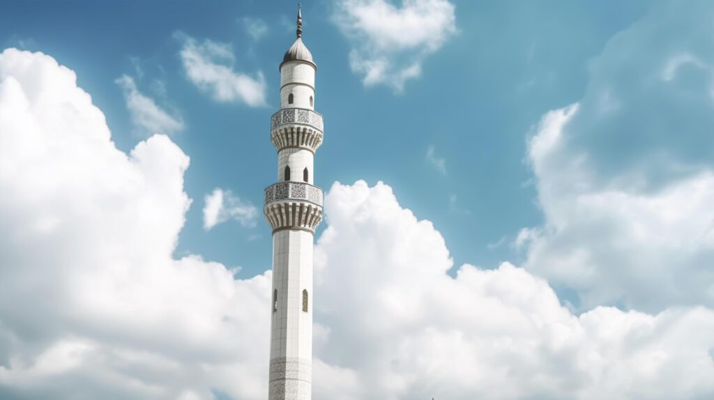 White mosque minaret. Mosque minaret with cloudy sky in background. Stock Free