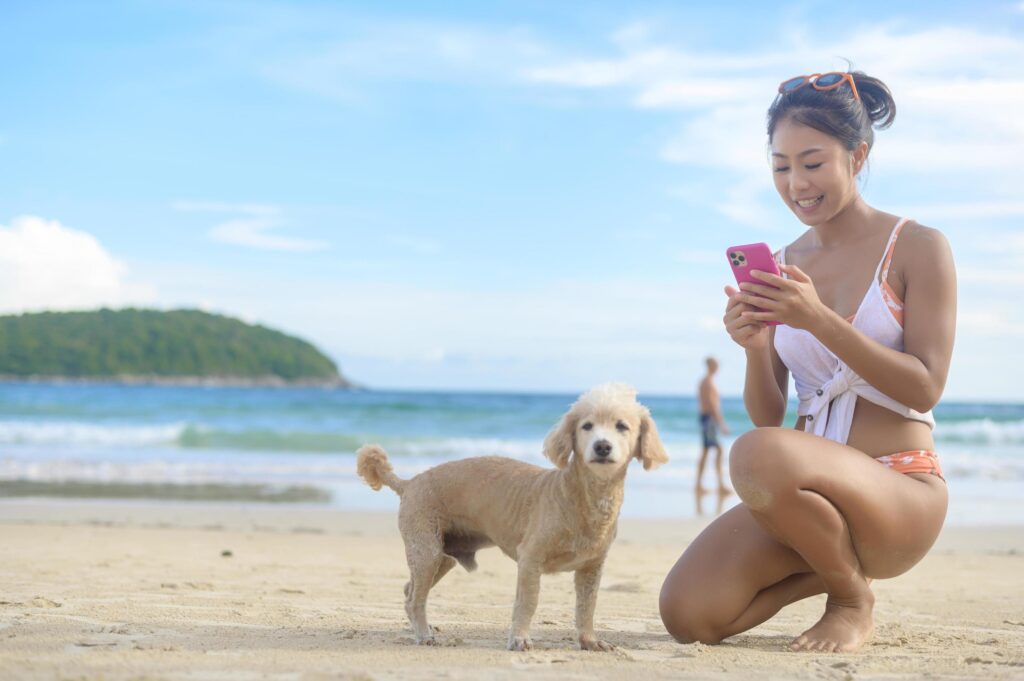 Young Beautiful woman in Bikini with her dog enjoying and relaxing on the beach, Summer, vacation, holidays, Lifestyles concept. Stock Free