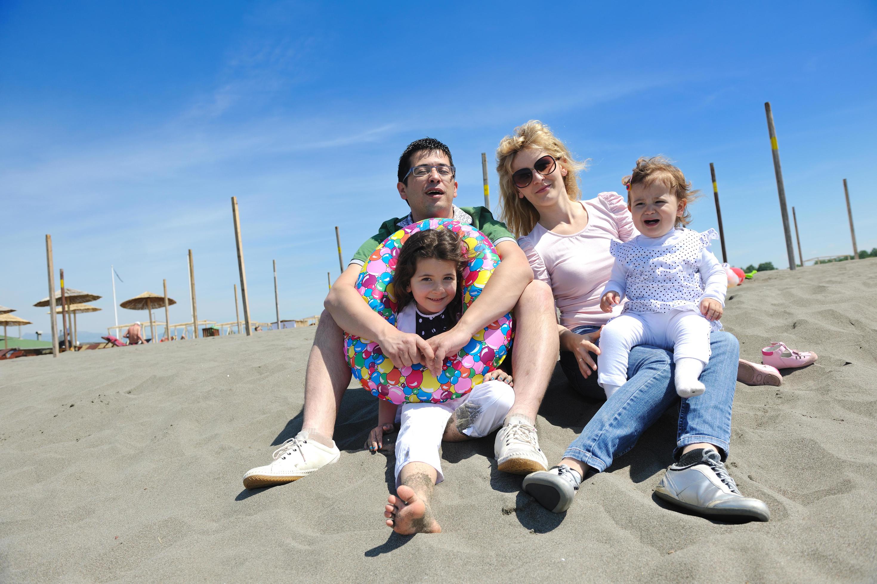 happy young family have fun on beach Stock Free