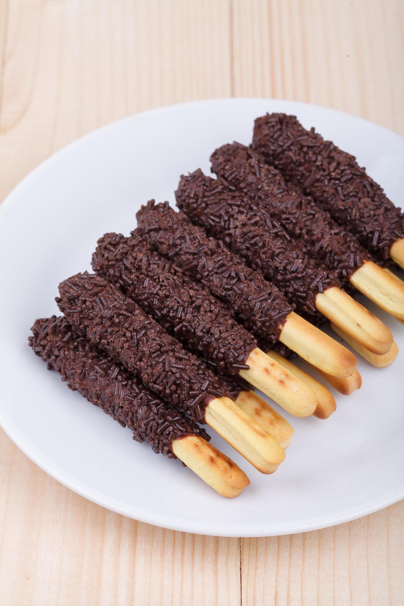 snack food biscuit stick chocolate coated on wood blackground Stock Free