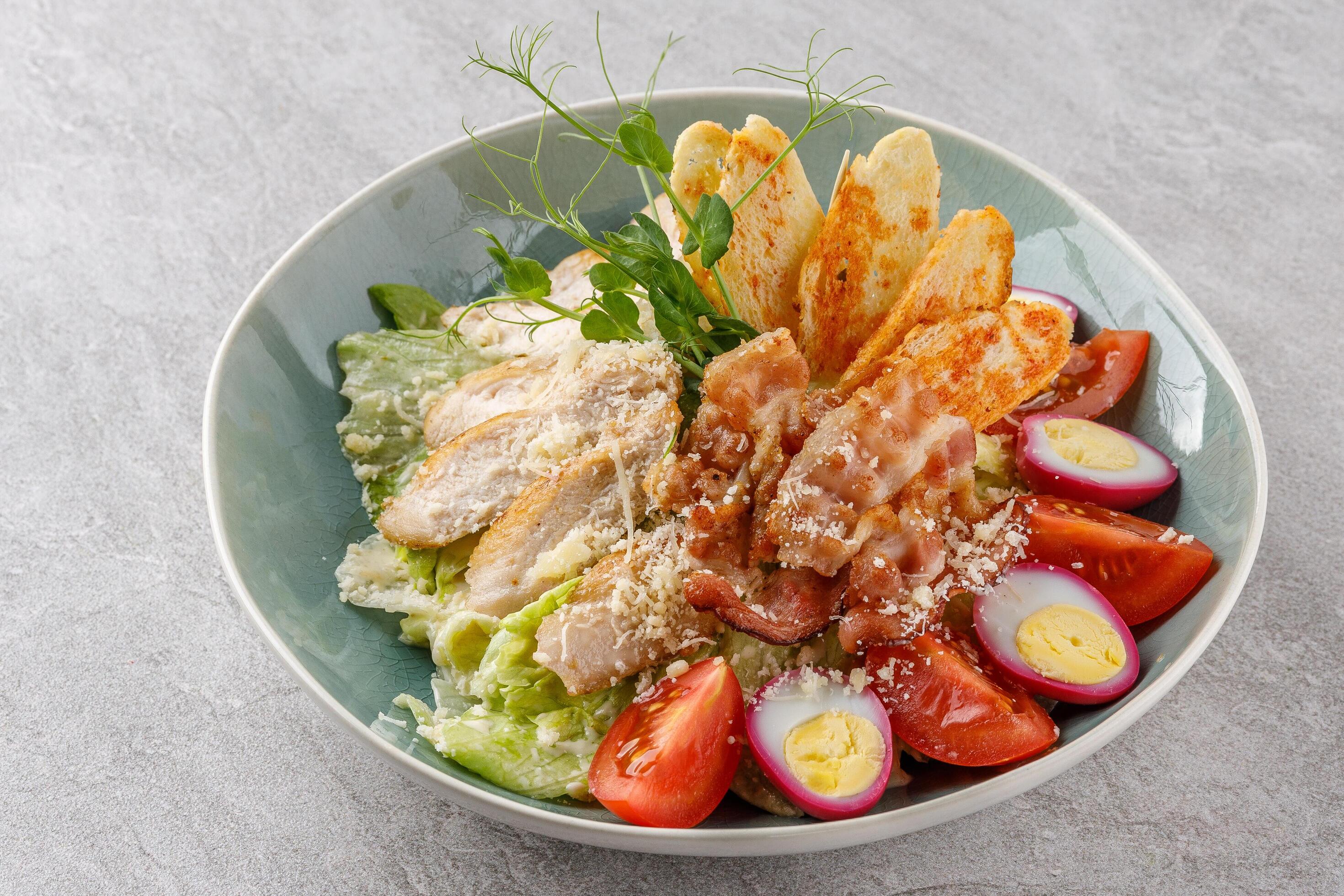 Caesar salad with chicken and bacon on a stone background studio food photo 4 Stock Free