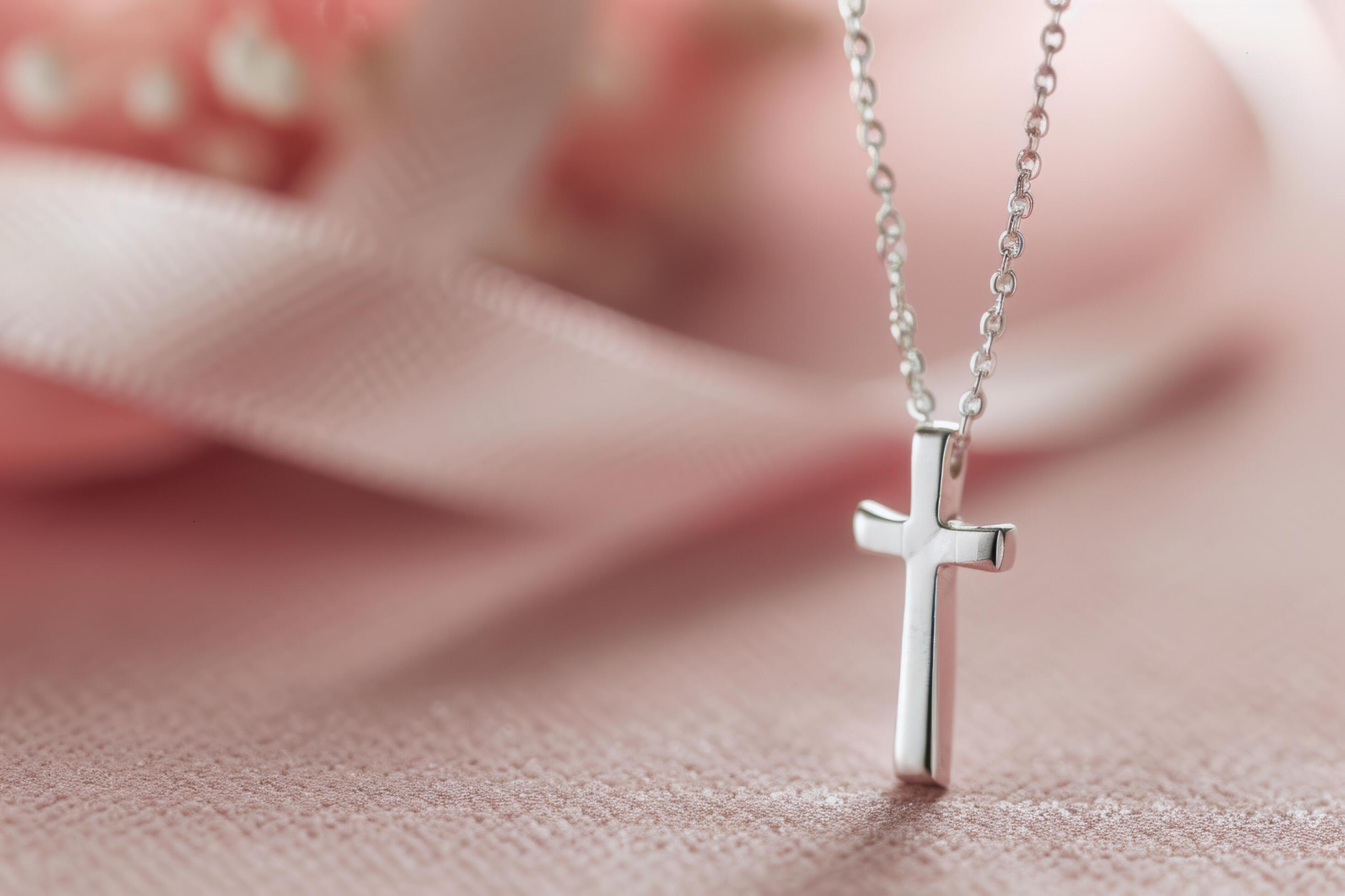 Silver Cross Necklace on Pink Background Stock Free