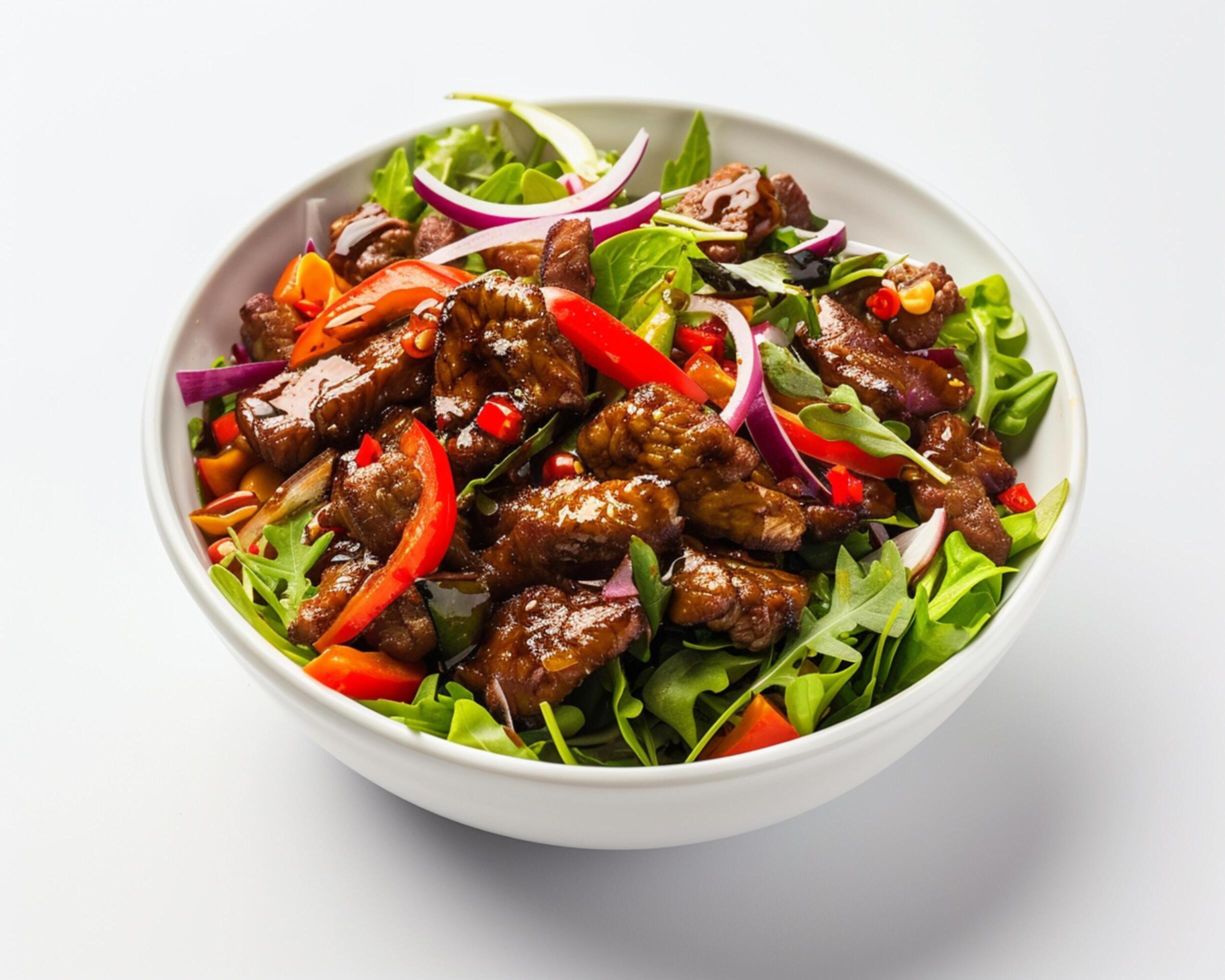 a bowl of meat and vegetables with a spoon Stock Free