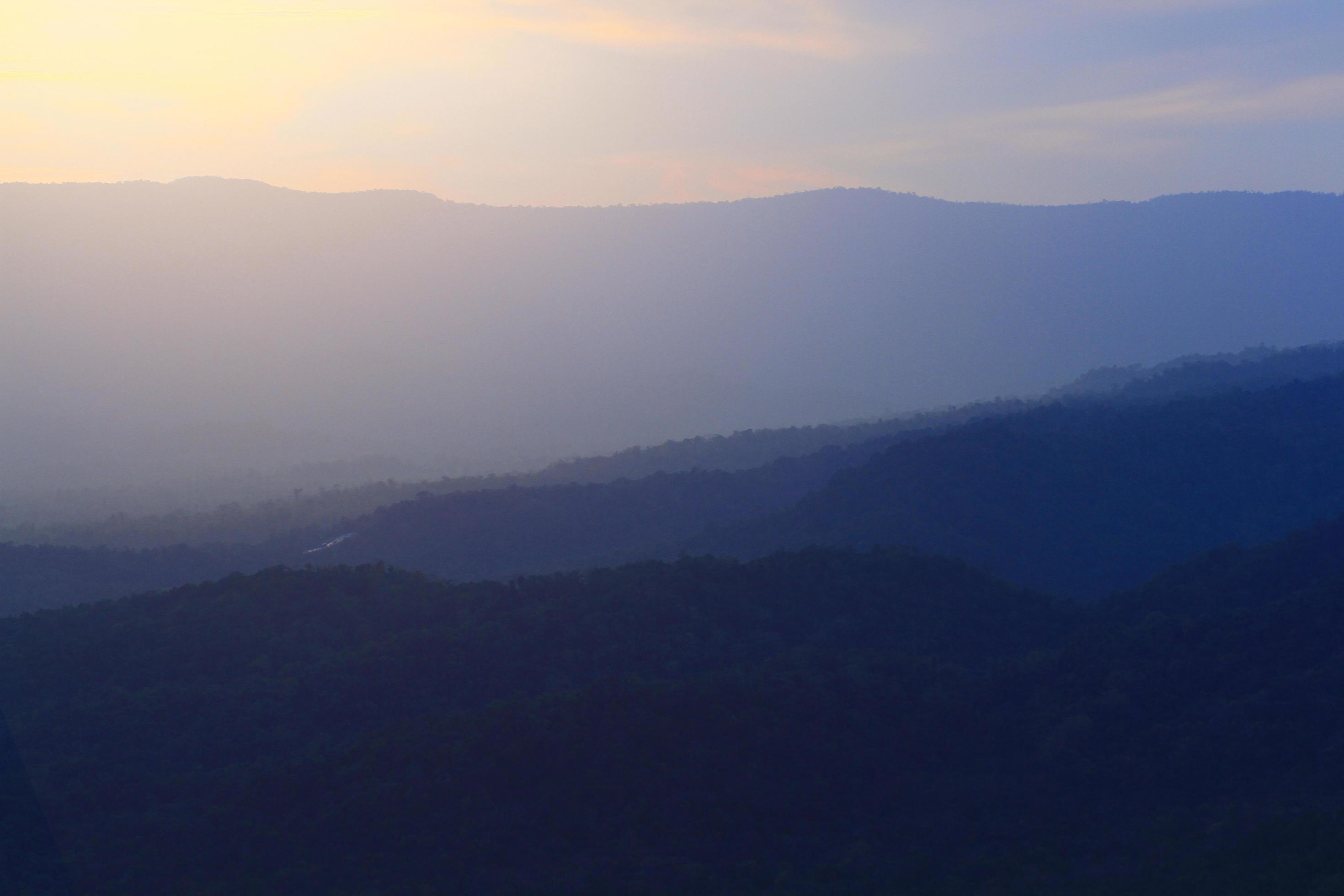 Beautiful landscape layers of mountain and Misty on hill valley in golden twilight of sunset at Thailand Stock Free