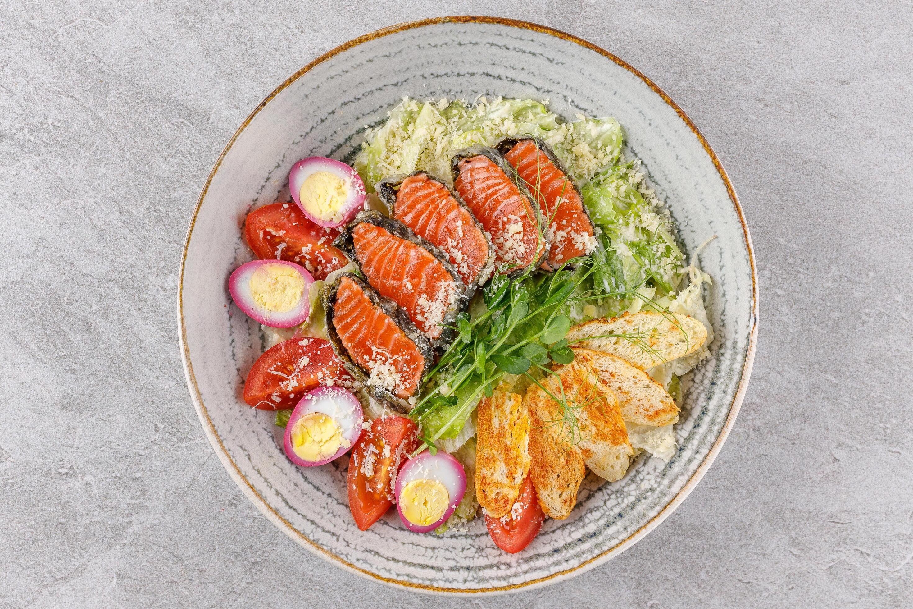 Caesar salad with baked salmon on a stone background studio food photo 4 Stock Free