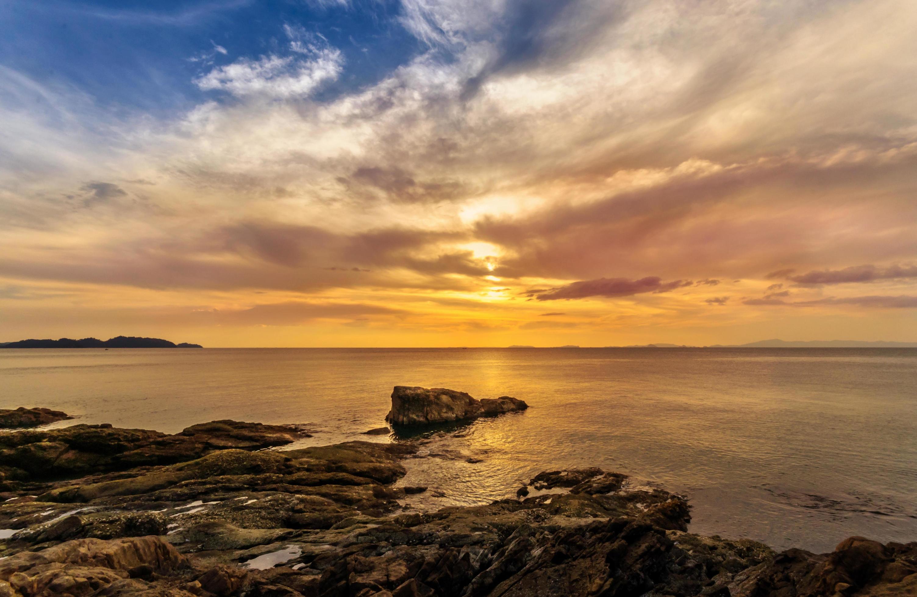 Landscape of beautiful seascape. Sea, rock and cloud in the sky at the sunset. Stock Free