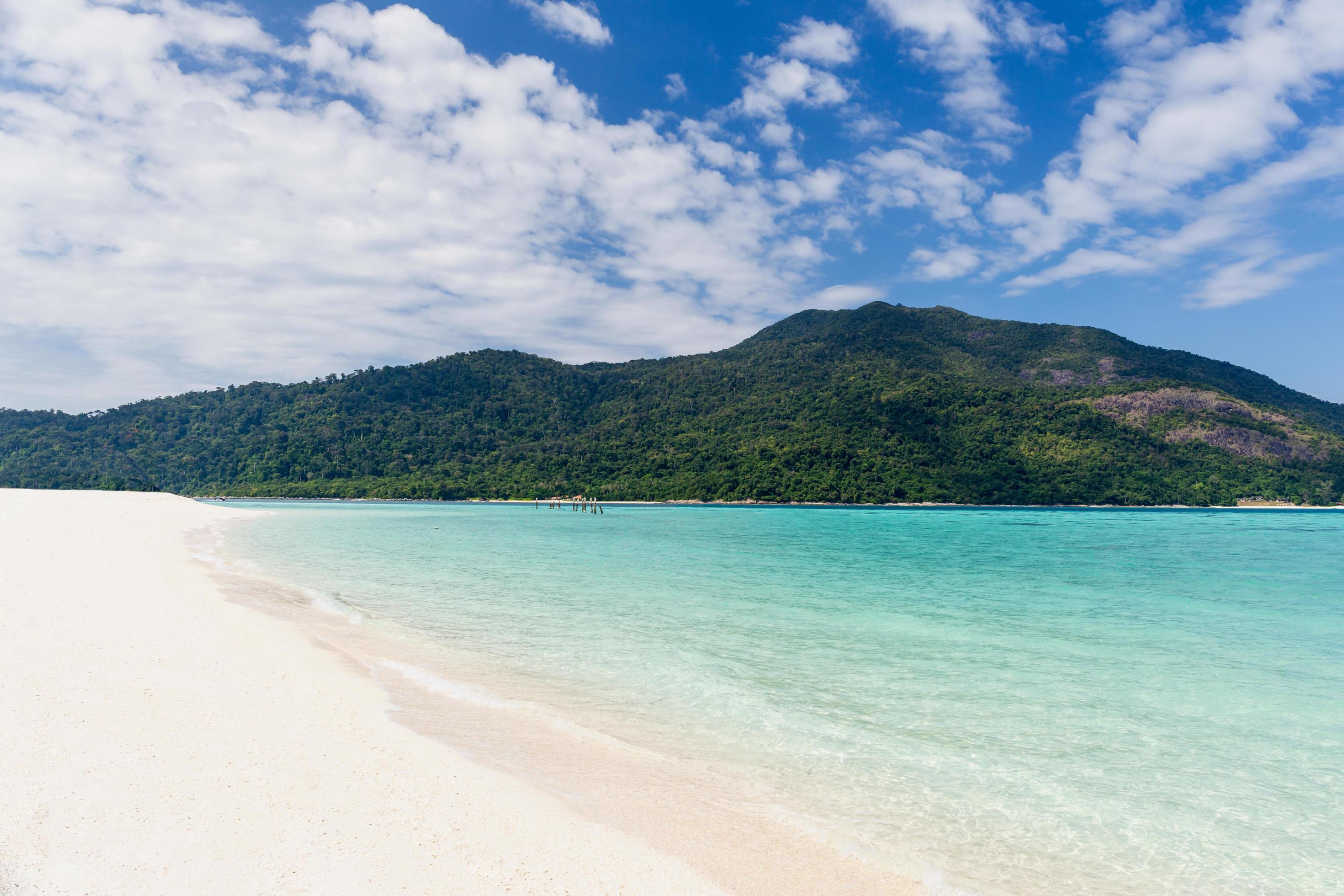 Beautiful sea with white sandy beach and blue sky in tropical island. Stock Free