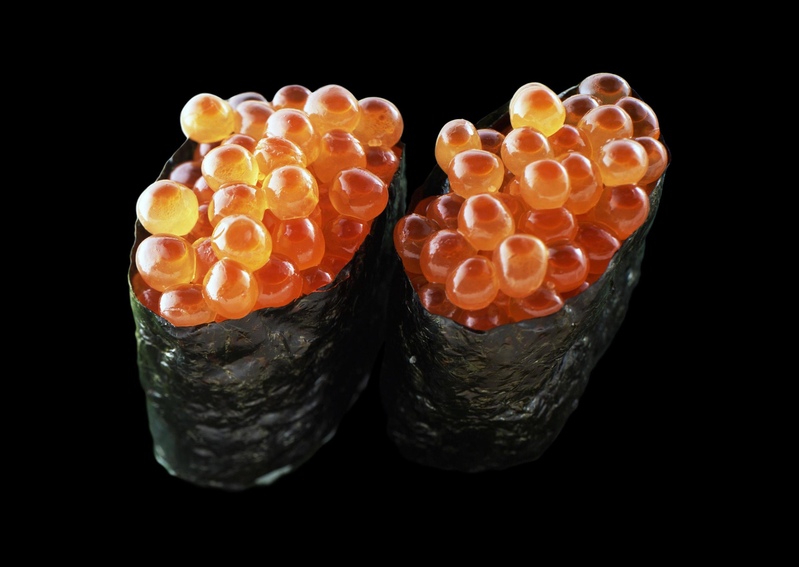 Ikura Sushi Japanese food style, Decorate with Salmon roe and seaweed isolated on black background Stock Free