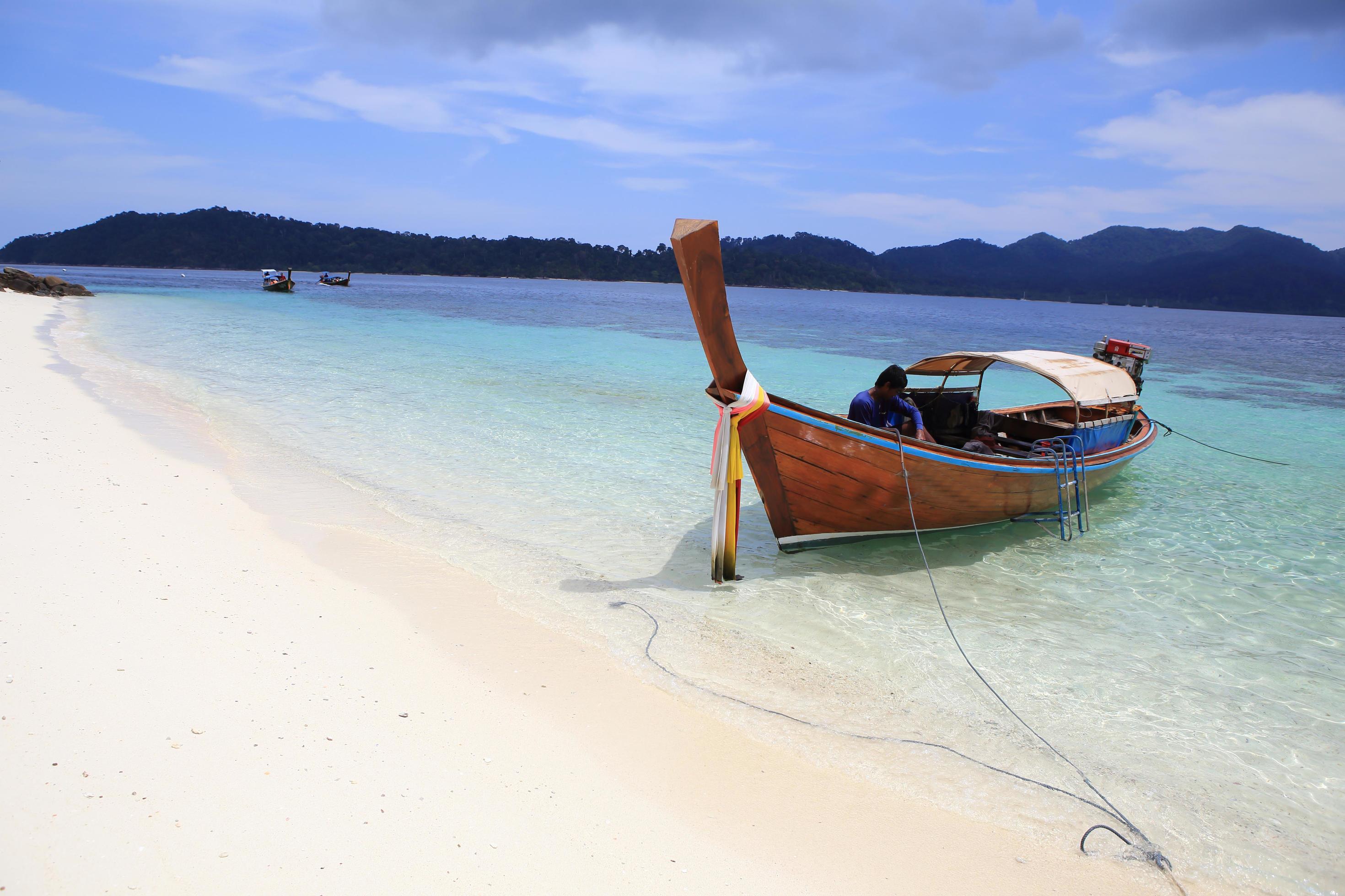 Traditional Thai longtail boat at the beach Stock Free