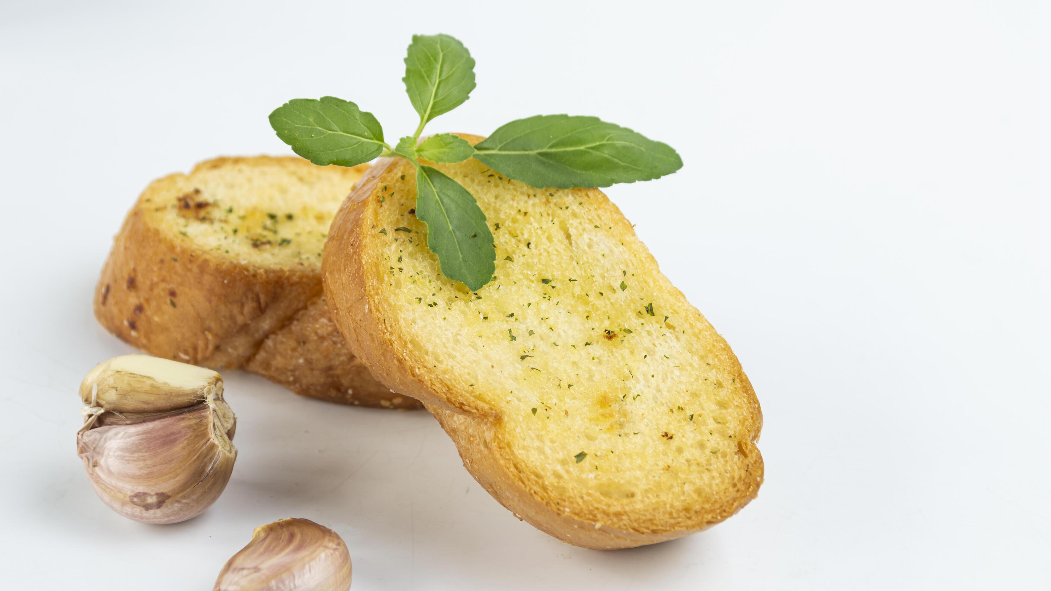 garlic bread with garlic and parsley on white background Stock Free