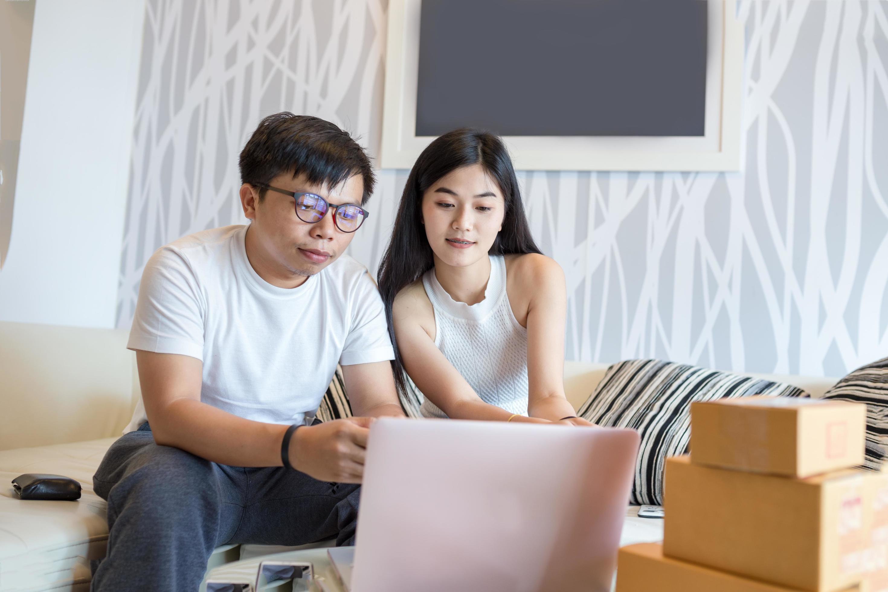 
									Young couple shopping online at laptop computer and pay with credit card and very happy in apartment of them. This is lifestyles of Asian young. Stock Free