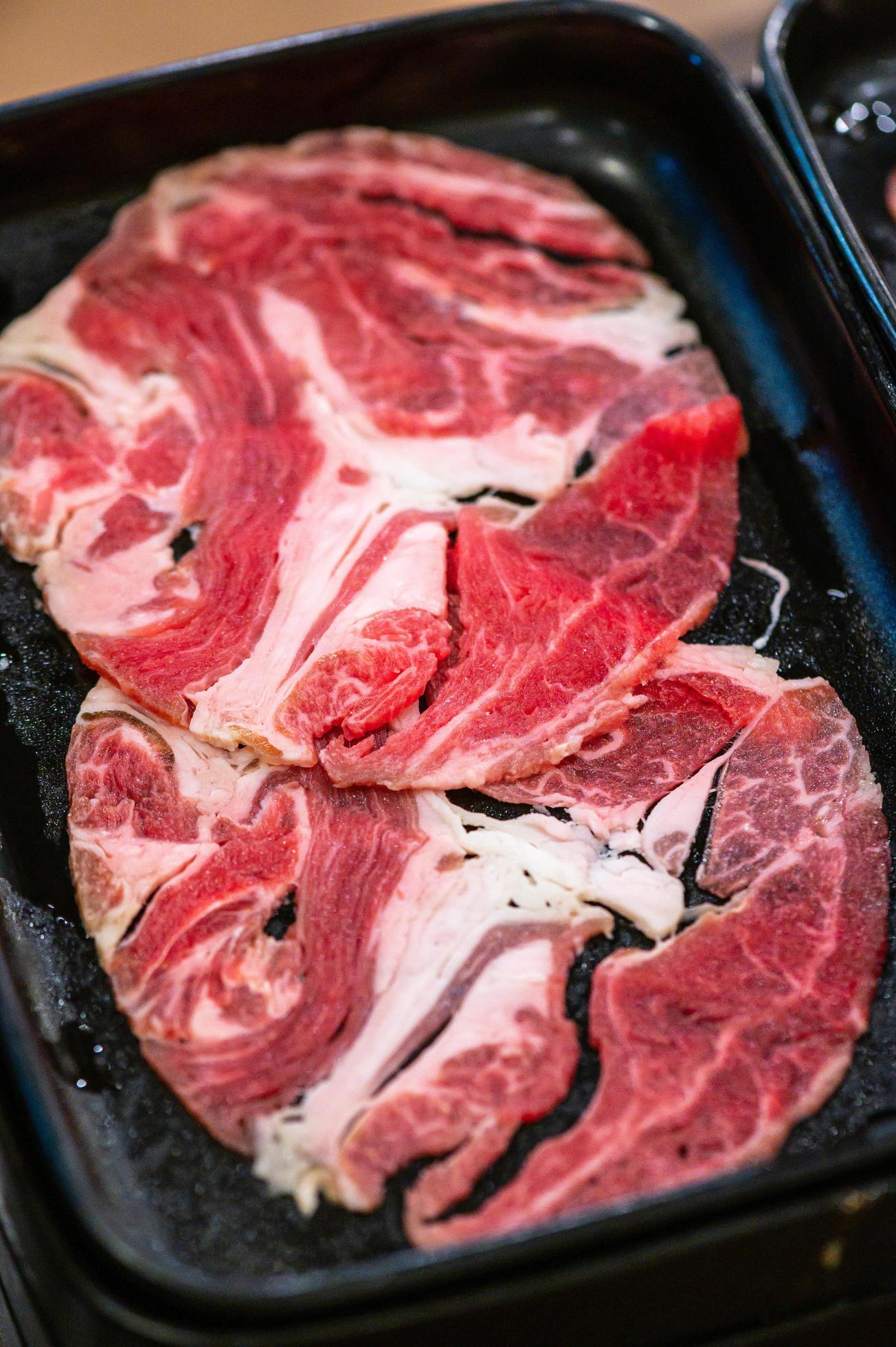 Slide raw beefs for Yakiniku. Thin piece beef for Shabu hotpot japanese food style. Close up fresh meat chuck eye for Sukiyaki. top view Stock Free