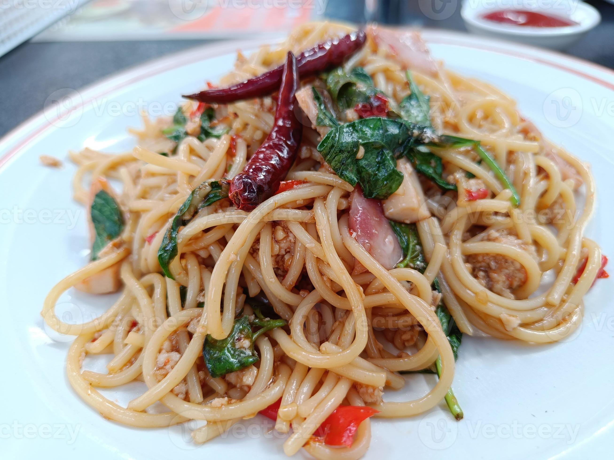 Spaghetti with Spicy pork and basil.Thai fusion food. side view Stock Free