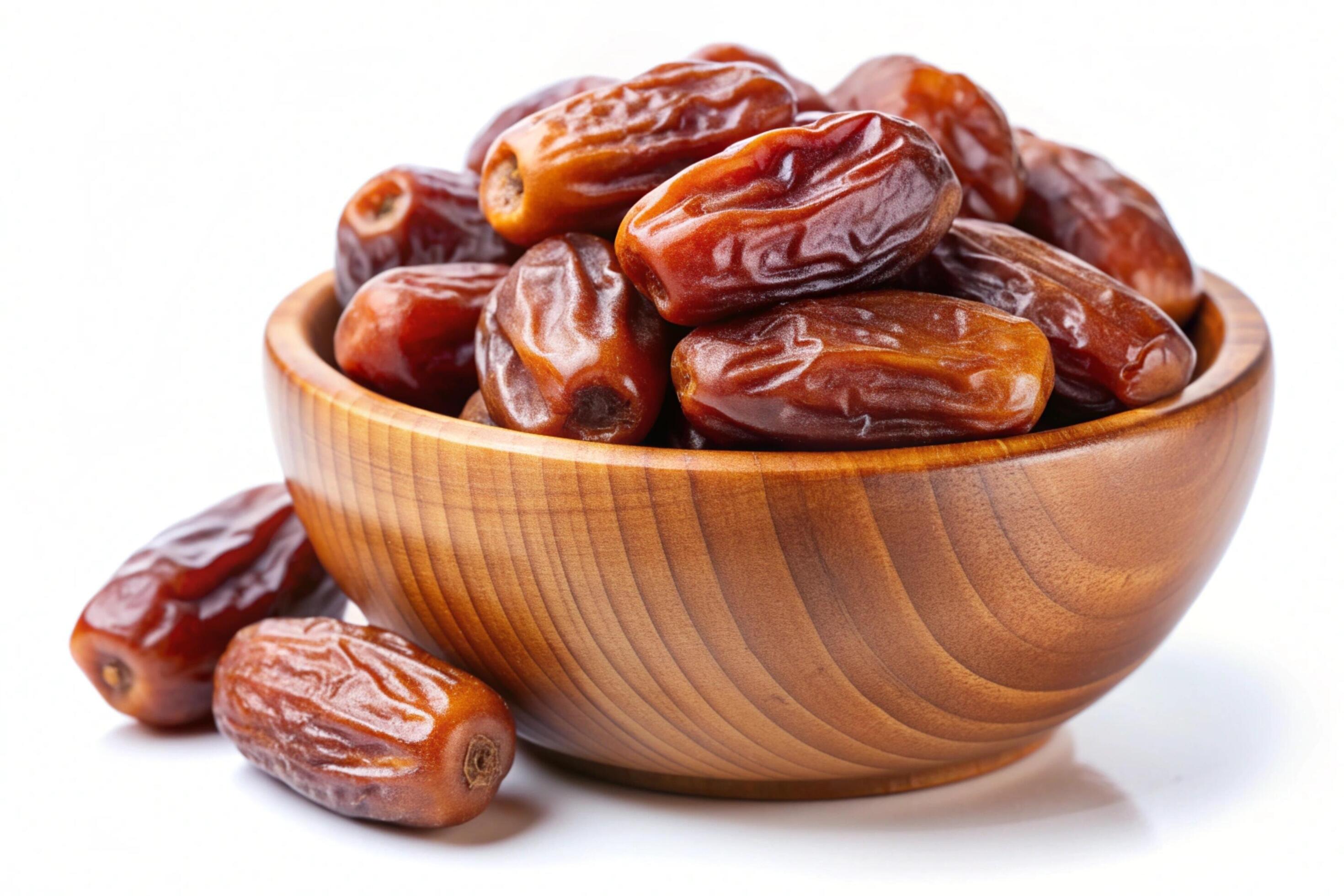 Dates in wood bowl isolated on white background Stock Free