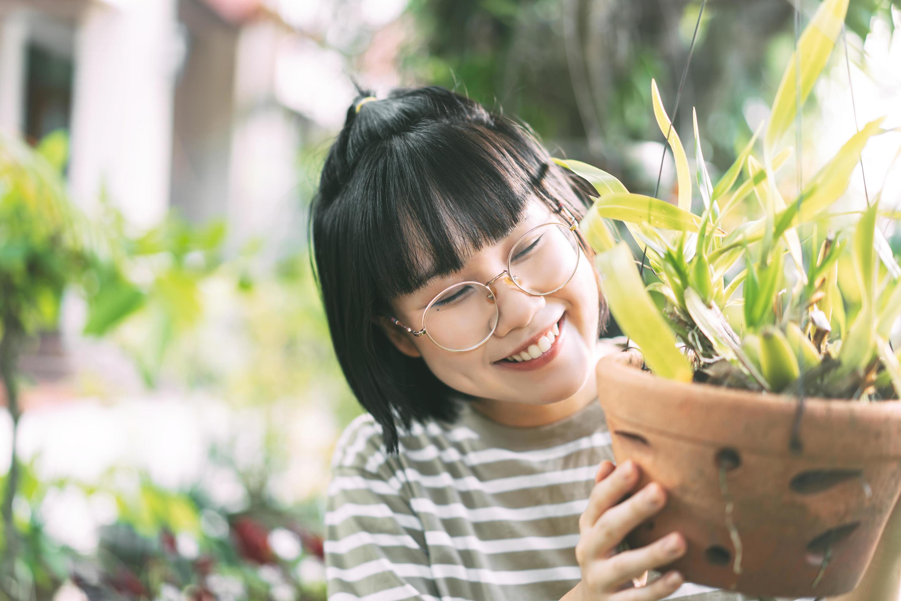 Young adult asian woman lifestyle at home garden on summer day. Stock Free