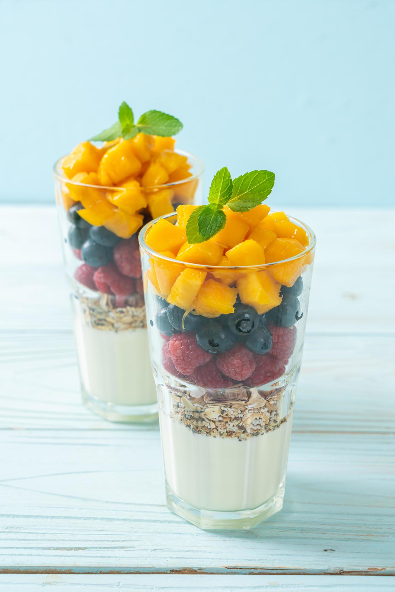 Homemade mango, raspberry, and blueberry with yogurt and granola – healthy food style Stock Free