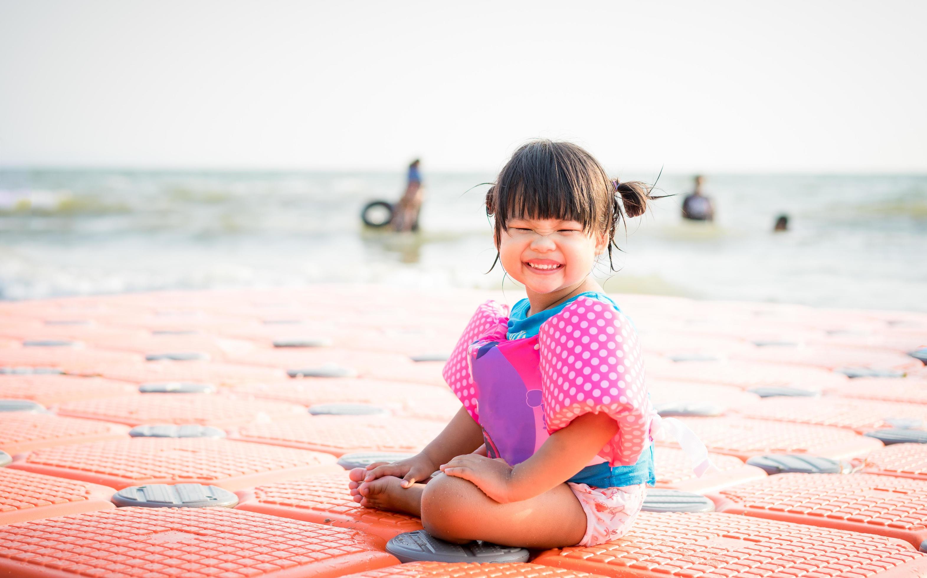 Little asian girl smiling on the beach Stock Free