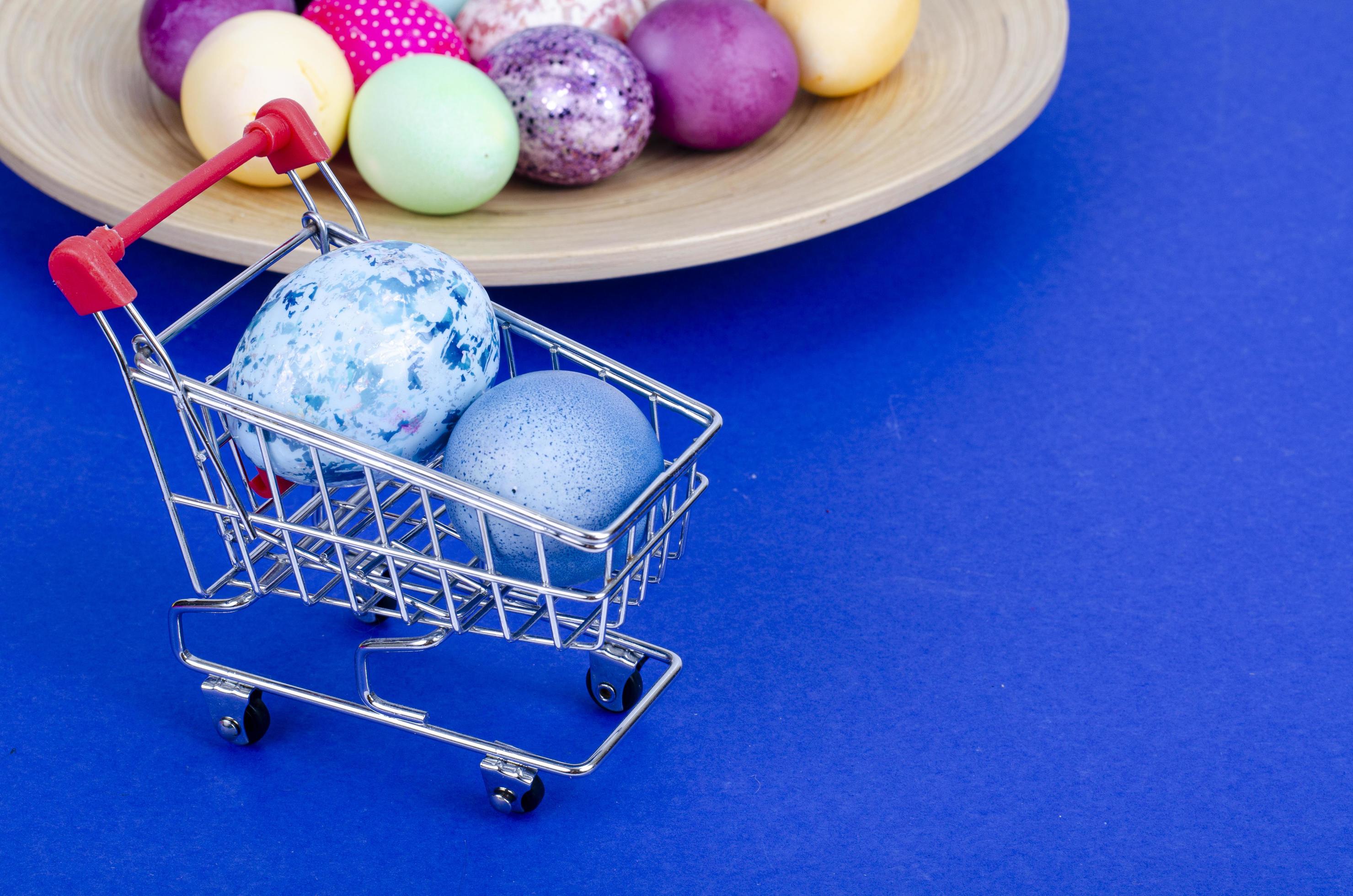 Grocery supermarket cart filled with chicken eggs. Concept of preparing for Easter, buying food. Space for text. Studio Photo Stock Free