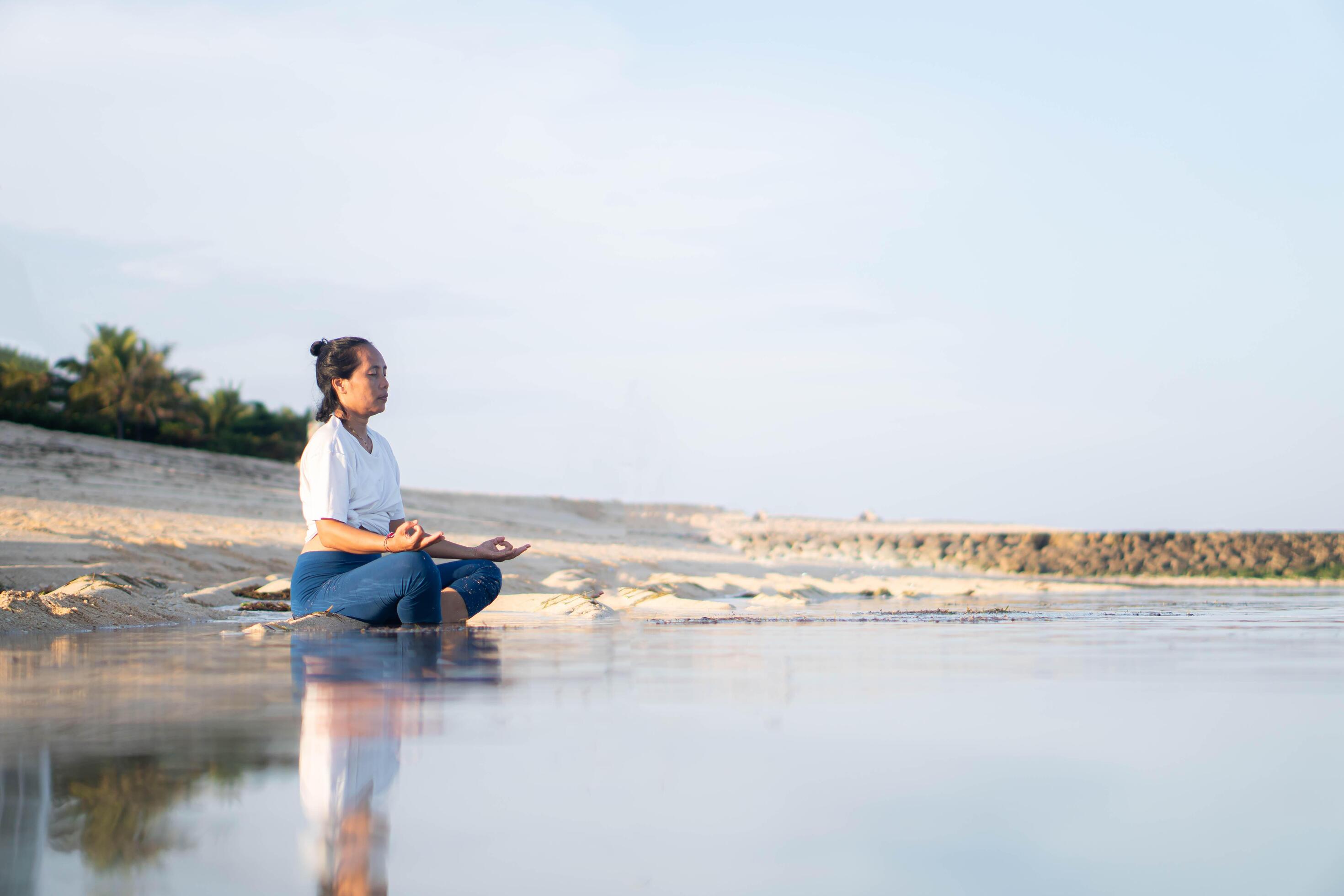 healthy woman with beautiful body doing yoga at sunrise on the beach, yoga poses Stock Free