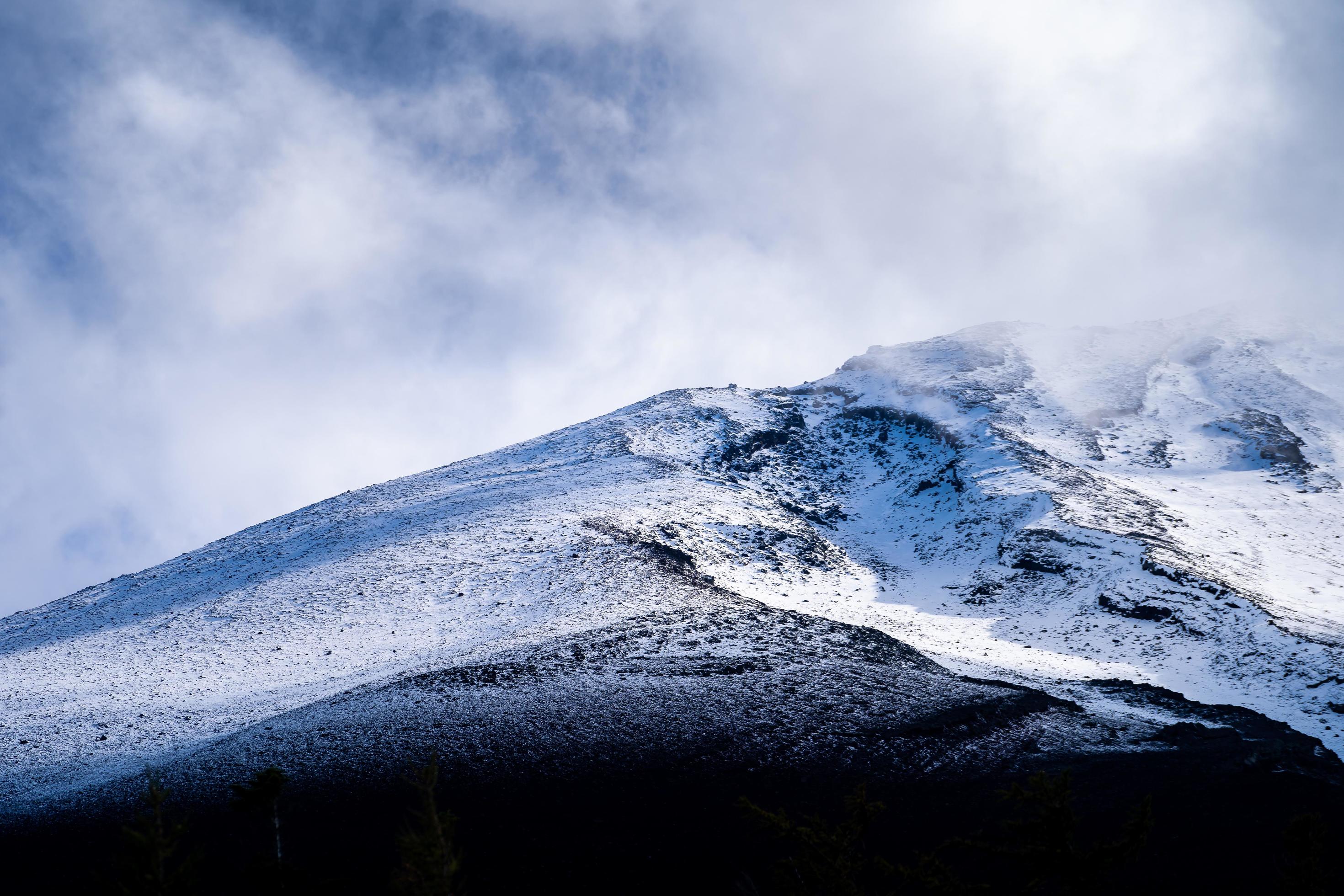 Close up top of Fuji mountain with snow cover and wind on the top with could in Japan. Stock Free