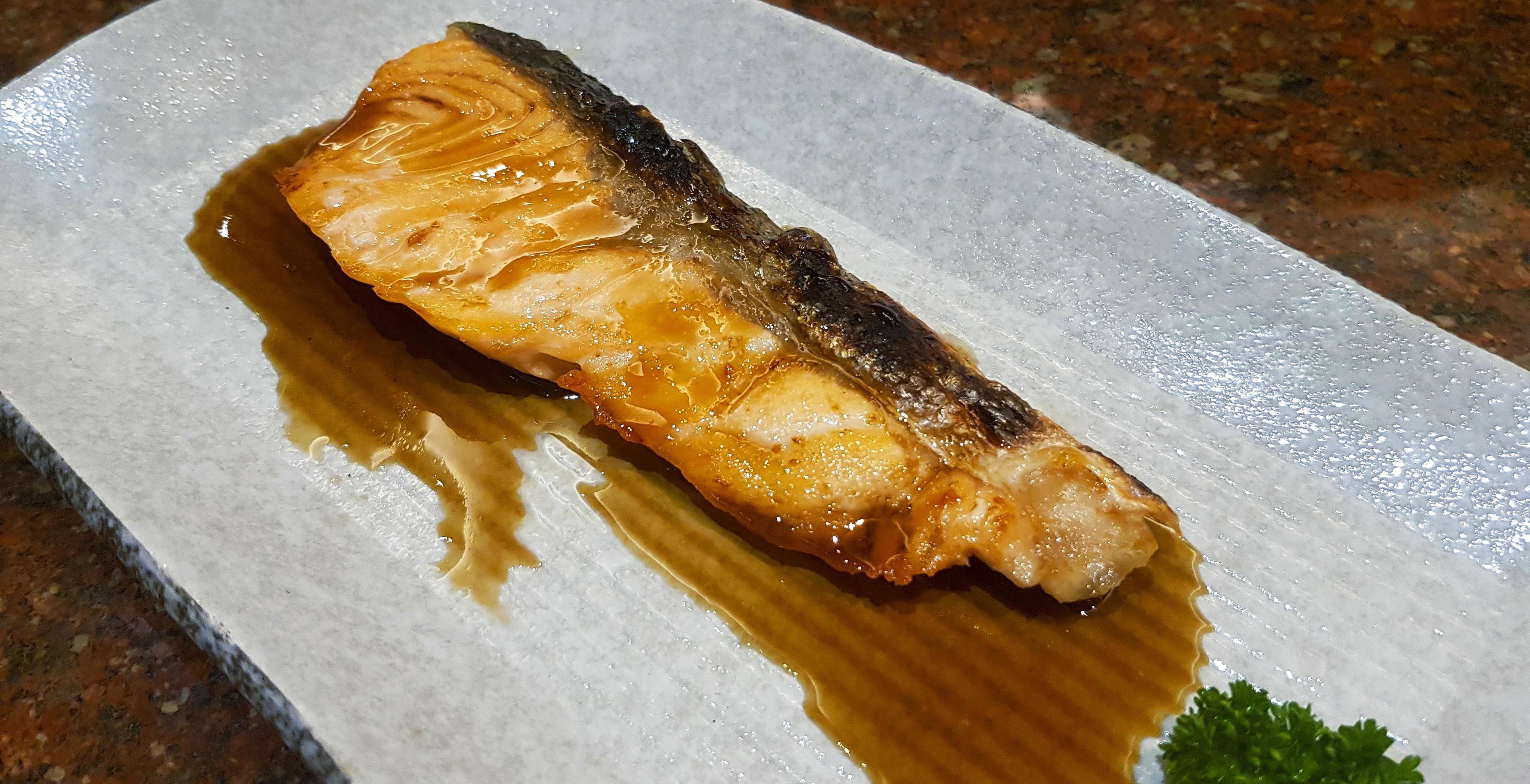 Grilled fresh salmon with Teriyaki sauce on white plate or dish at Japanese restaurant. Top view of Asian or fish food. Close up Barbeque seafood. Stock Free