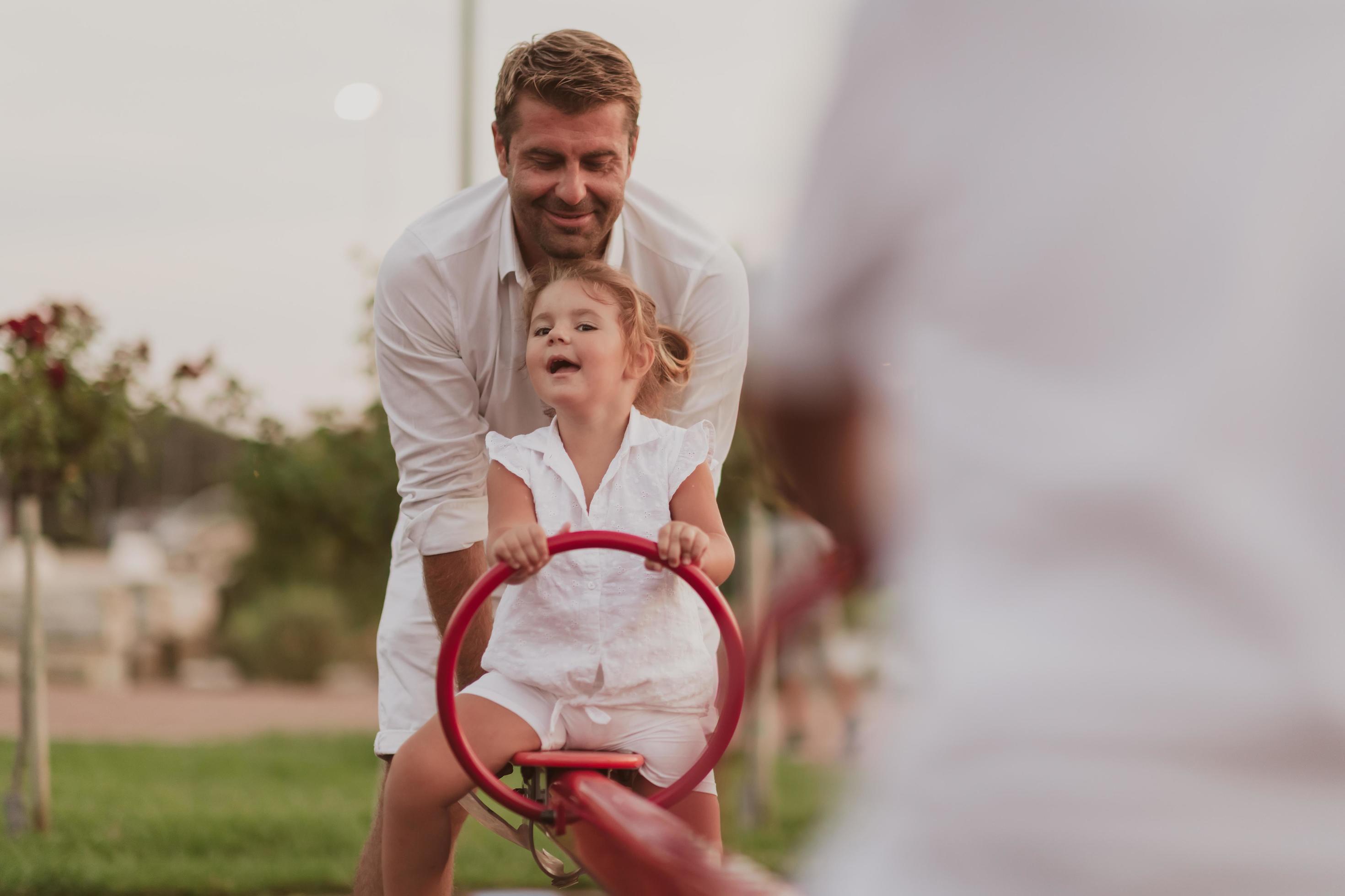 An elderly man in casual clothes with his daughter spends time together in the park on vacation. Family time. Selective focus Stock Free