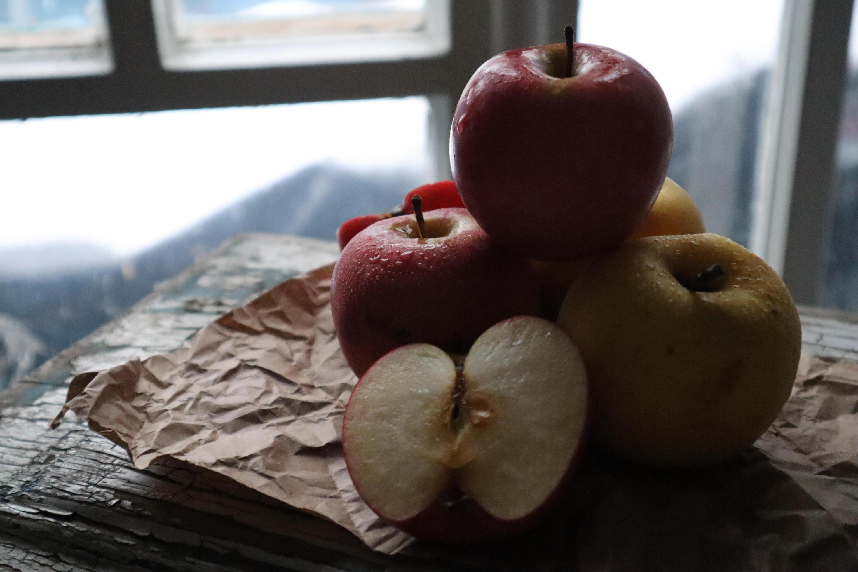 Cozy still life food photography Red apples cut half on a craft paper Stock Free