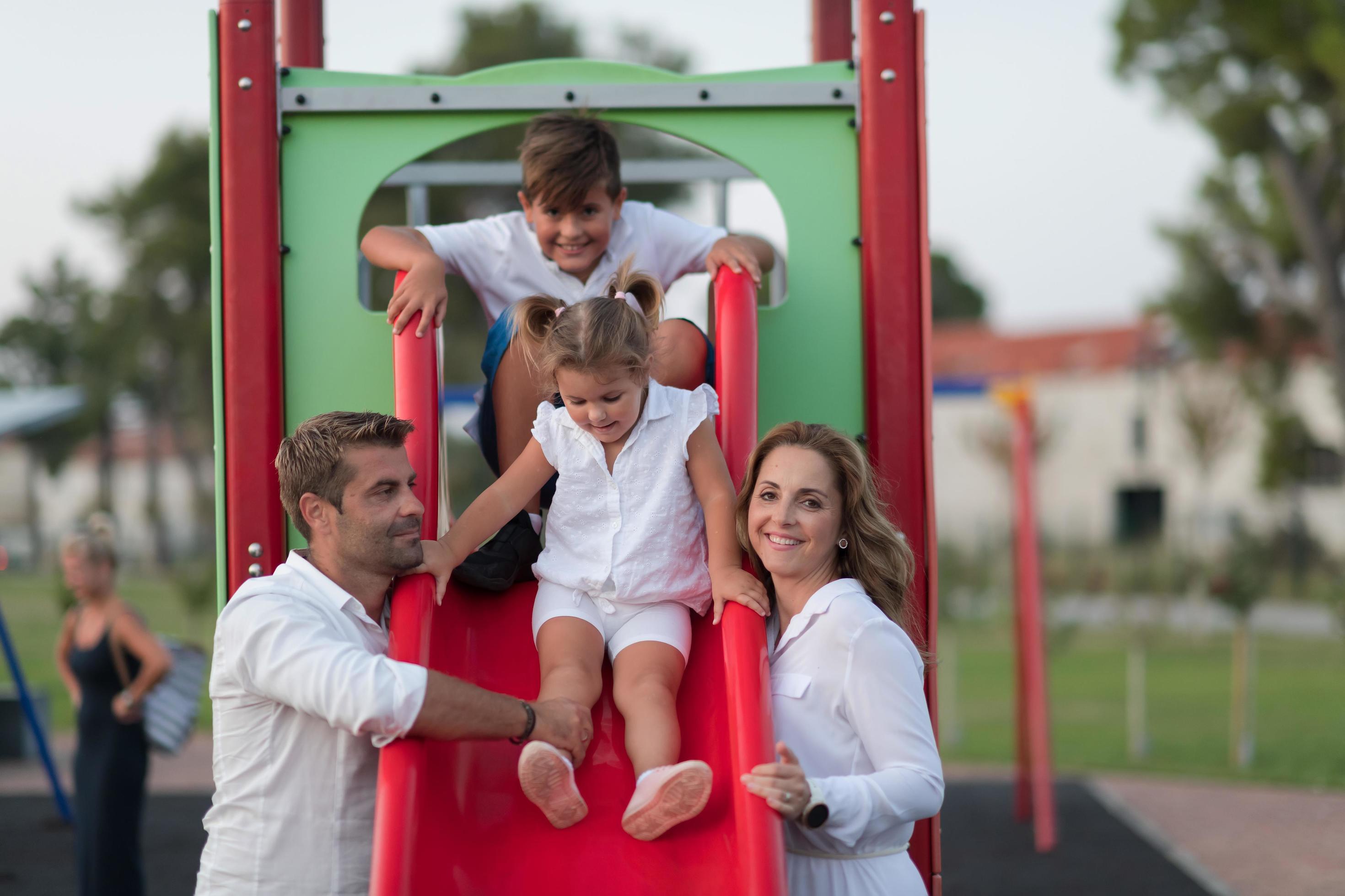 Senior couple in casual clothes with their children spending time in park a vacation together. Family time . Selective focus Stock Free