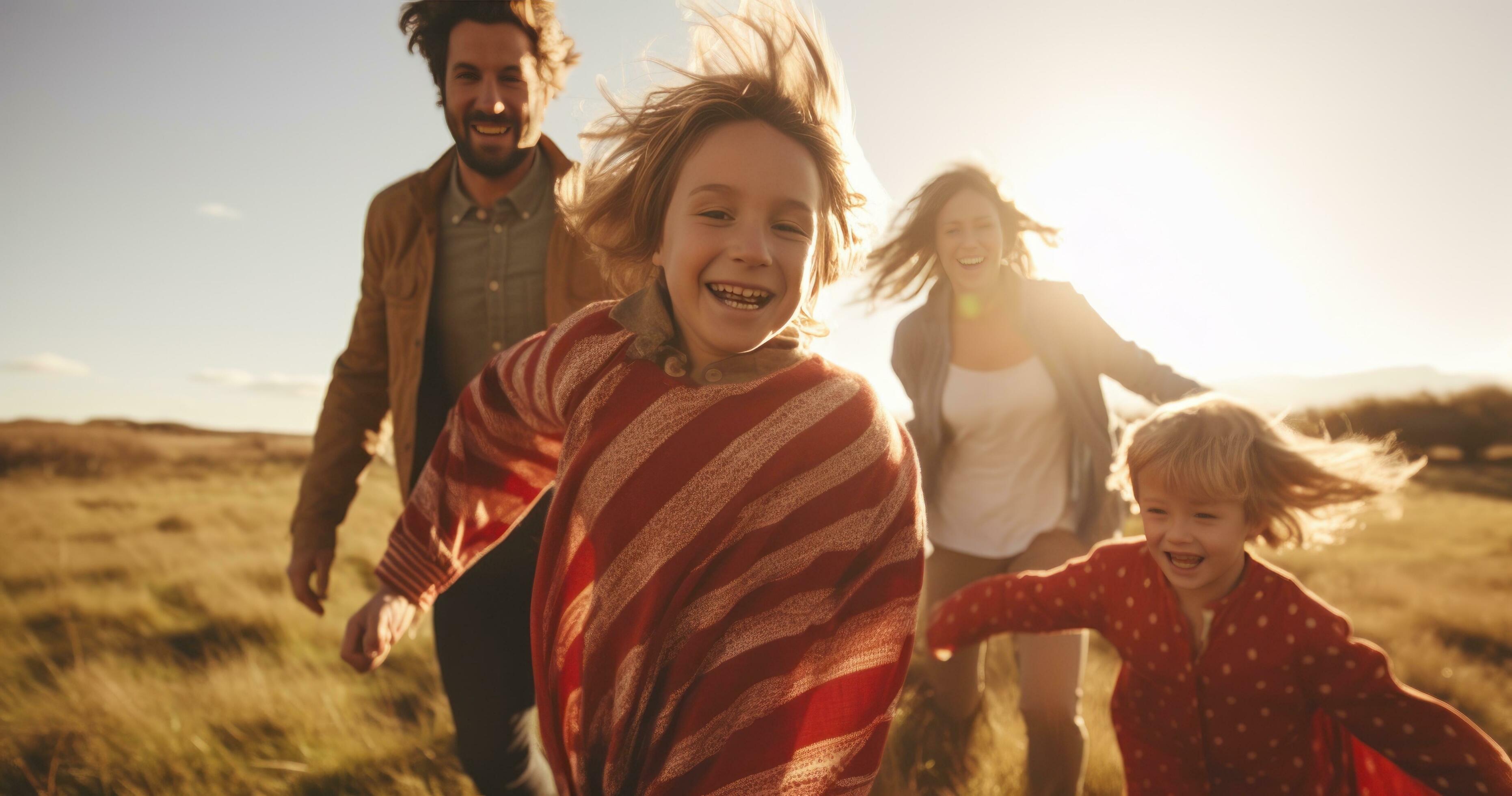 Happy family in running in summer field Stock Free